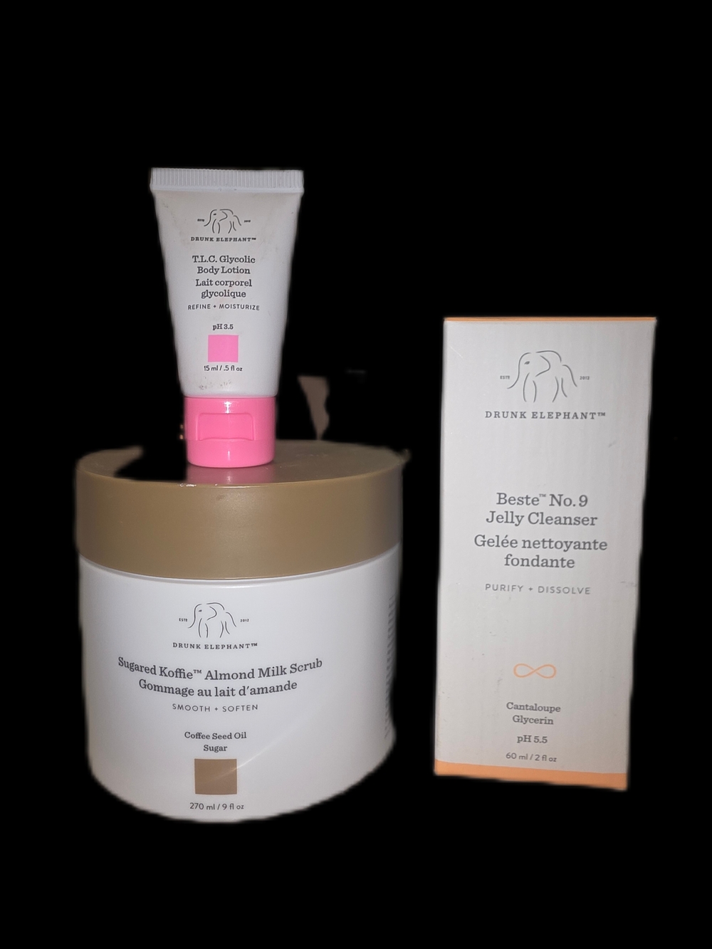 Drunk Elephant skincare set — white, gold, pink